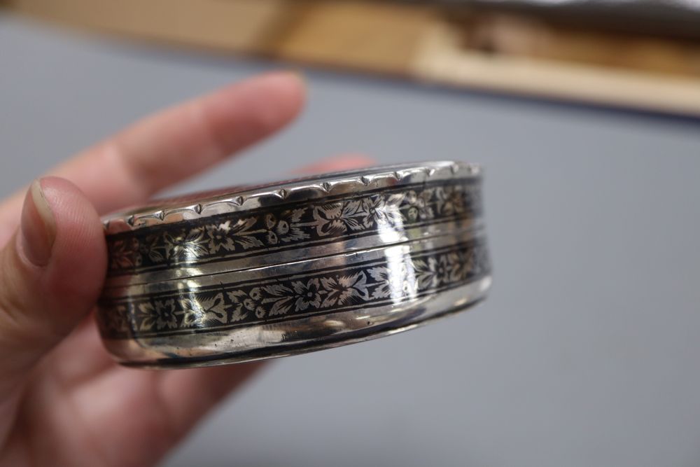 A 20th century Persian white metal and niello circular box and cover, 8cm, gross 3oz.